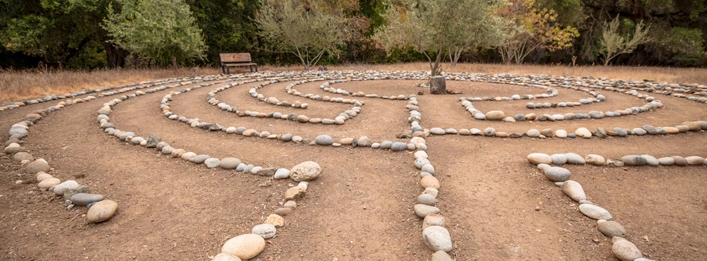  A photo of the retreat center’s labyrinth, a meditation maze of stones laid in concentric circles on smoothed ground.